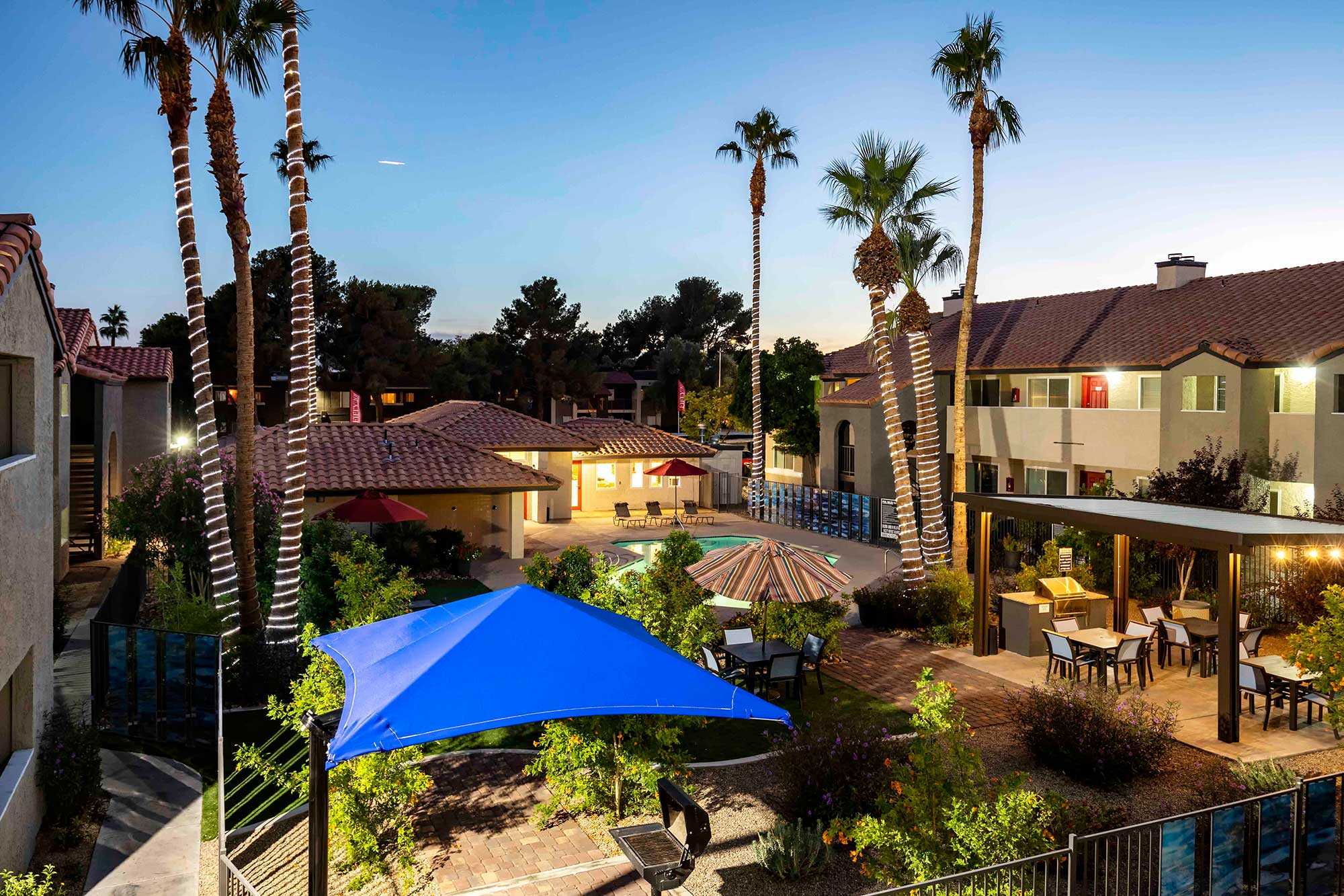 Fifty 101 apartments overview nightshot community pool outdoor seating eating area